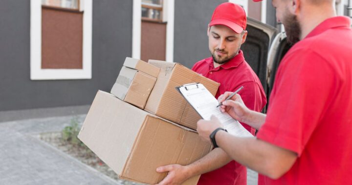 Professional movers in Newark NJ carrying packed boxes